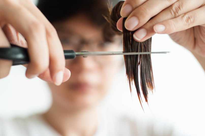 woman cutting her own hair