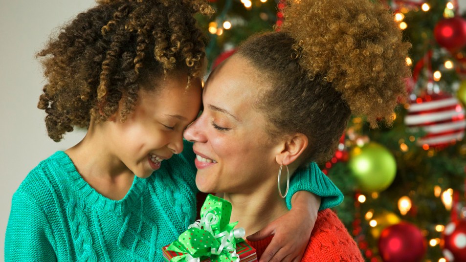 Mom and daughter hugging with Christmas presents