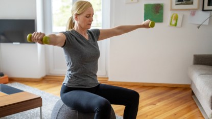 Woman exercising with weights at home