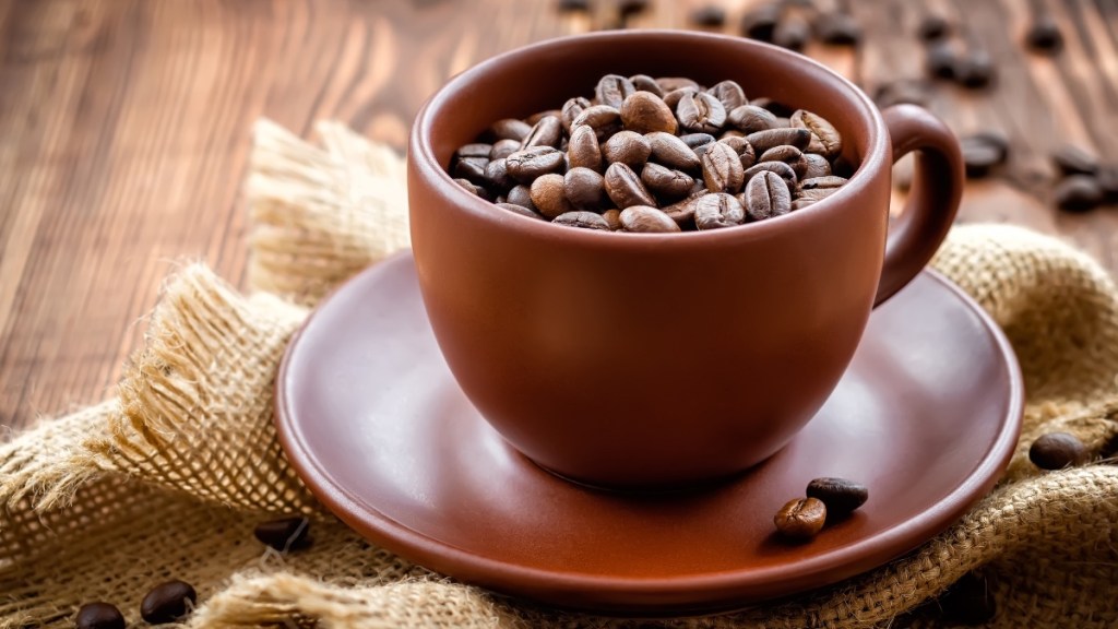 A brown mug with coffee beans, which contain chlorogenic acid