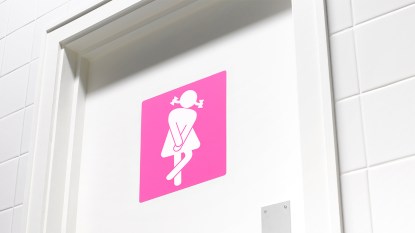 Women's restroom sign with illustration of a woman crossing her legs: natural remedies for incontinence