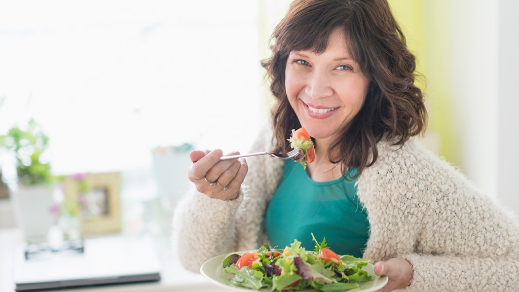 woman eating a salad: natural incontinence remedies