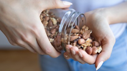 Woman pouring nuts into her palm