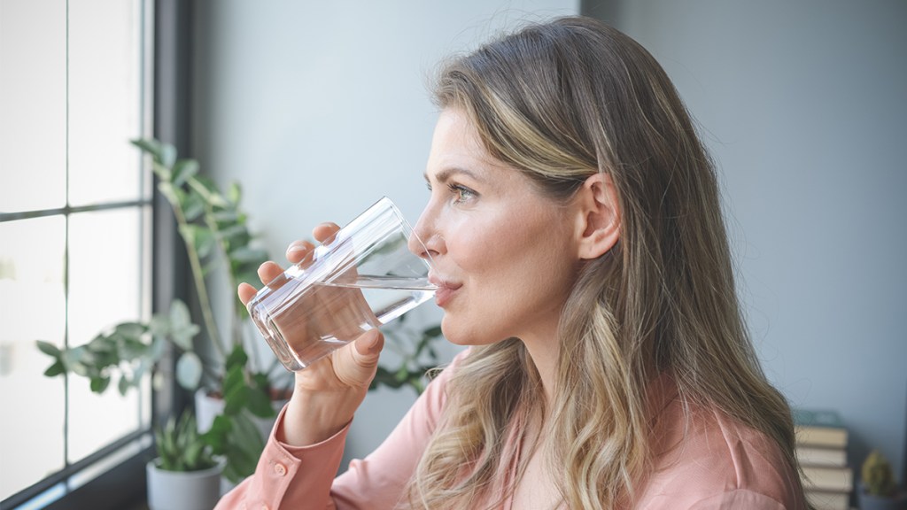 woman drinking water: natural remedies for incontinence