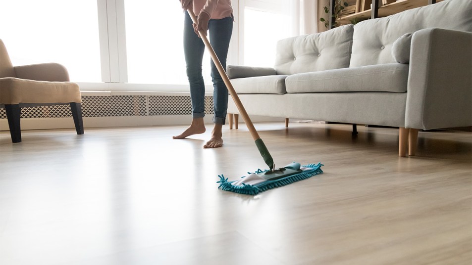 woman deep cleaning hardwood floor