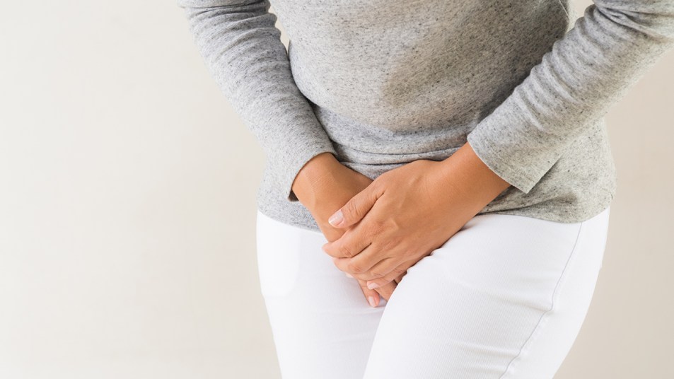 woman holding her bladder: UTI that won't go away