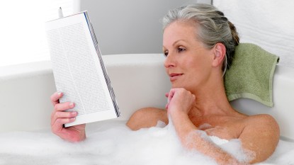 Woman reading in bath