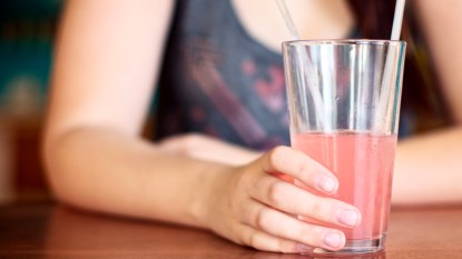 Woman with a glass of pink lemonade