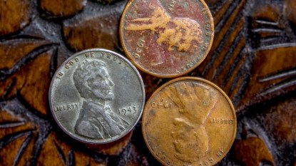 Silver penny with copper pennies