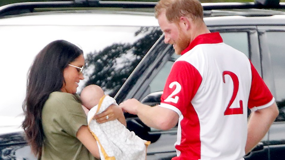 Prince Harry with Meghan Markle holding Archie