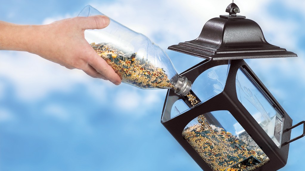 Easily refilling a bird feeder is one of many uses for plastic bottles