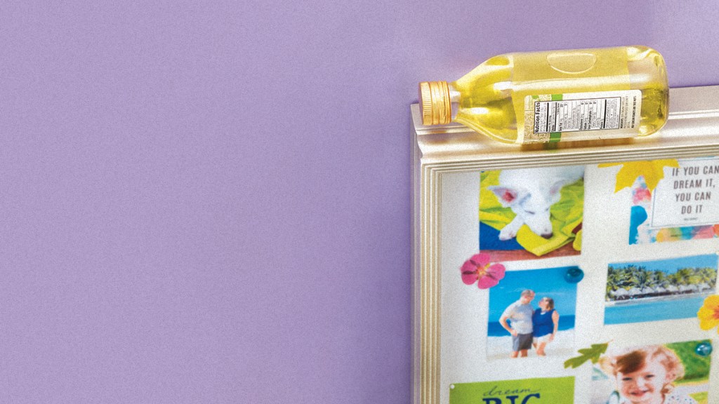 plastic olive oil bottle laying on top of a picture frame, doubling as a level: uses for plastic bottles