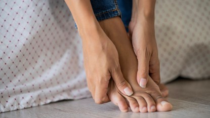 Woman's hands massaging her foot