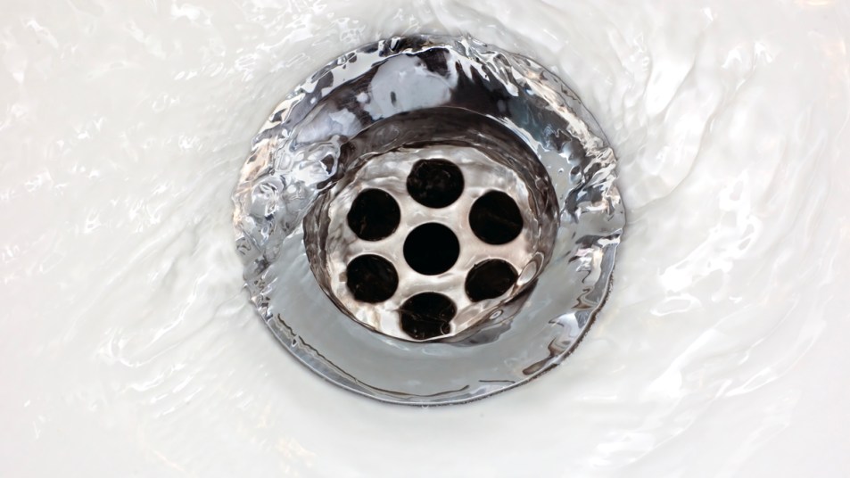 Shower drain with water pouring into it