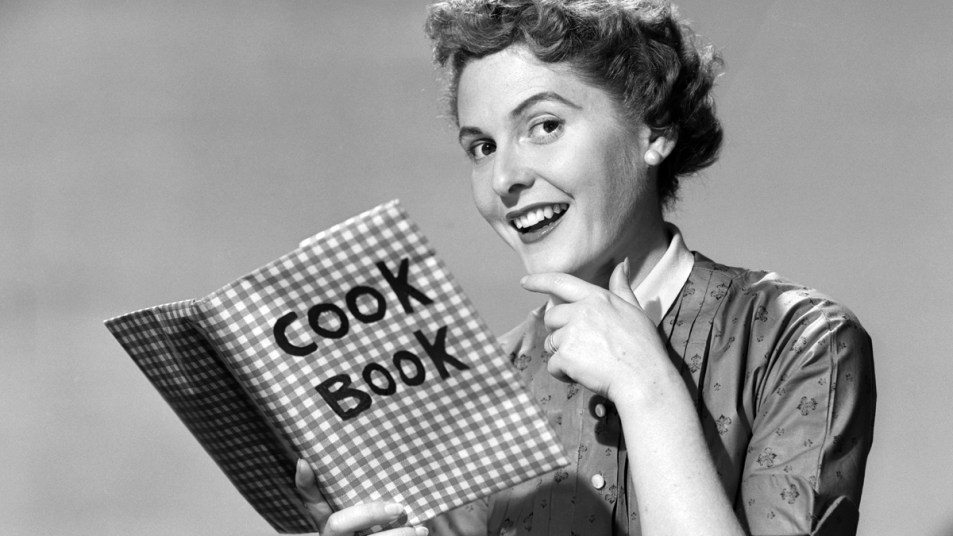 1950s woman with a cookbook