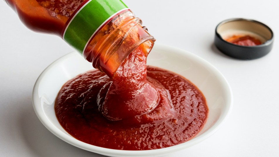 Pouring ketchup into a bowl