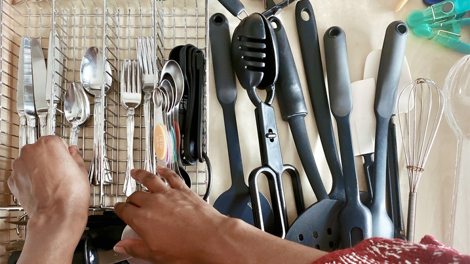 Woman organizing a silverware drawer
