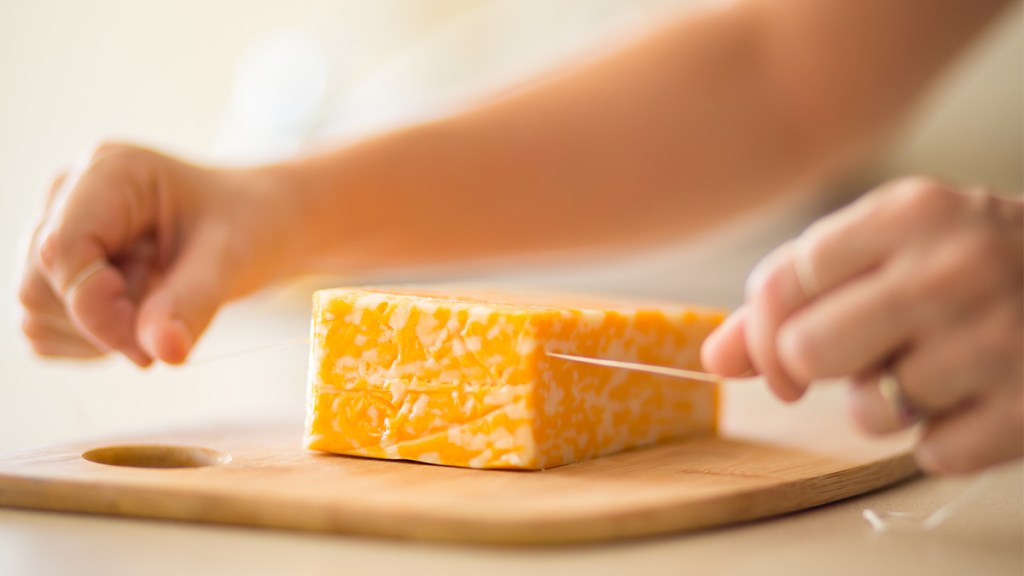 woman slicing a block of cheese with dental floss: uses for floss