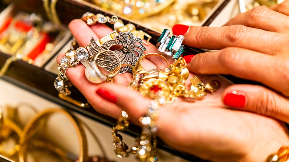 woman sorting through a pile of jewelry