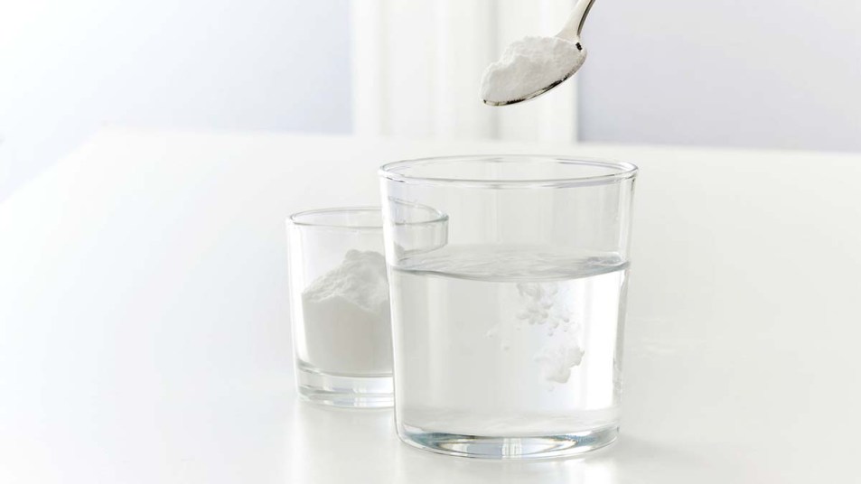 Baking soda being dissolved in a glass of water