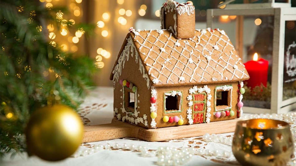 A gingerbread house sitting on a table with decorations