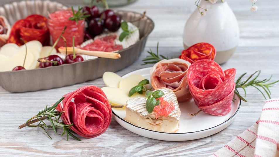 A salami rose on a charcuterie platter