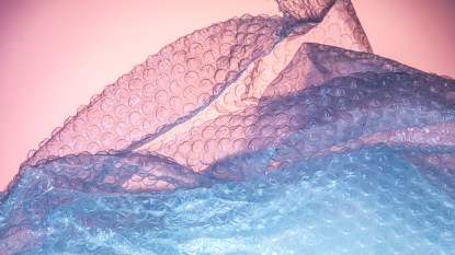 Close up blue bubble wrap on pink background