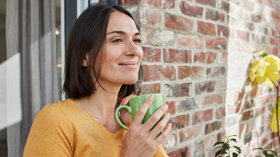 Smiling woman with cup of tea