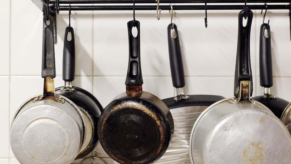 A set of warped skillets and pans