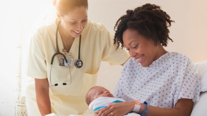 Nurse Helping A Mom With A Newborn