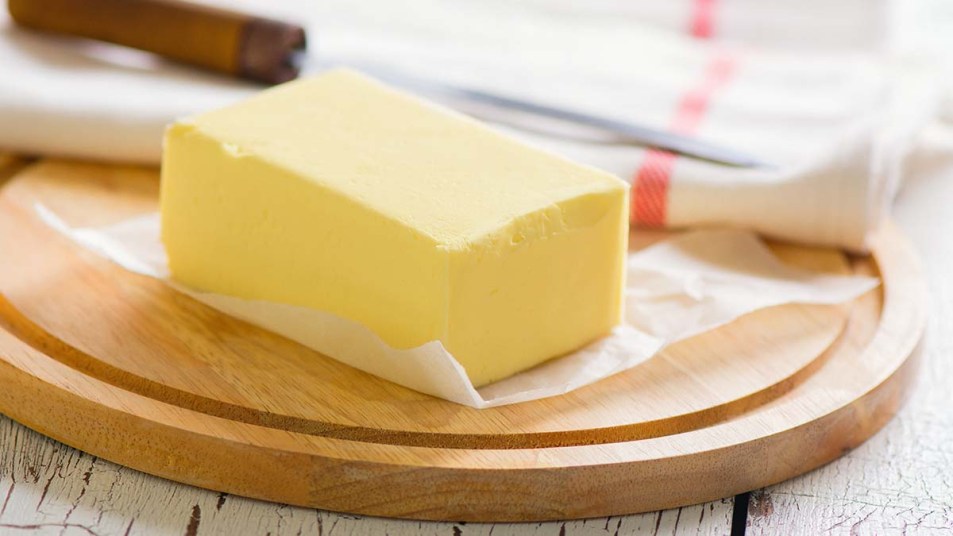Stick of butter on a wooden board
