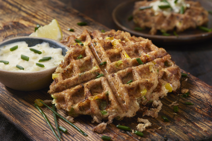 Crab cake waffles on a wooden board