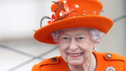 close up of Queen Elizabeth wearing bright orange, 2022