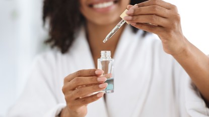 Woman holding a bottle of essential oil