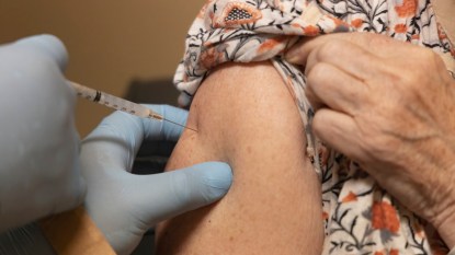 close up of mature woman receiving COVID-19 vaccine