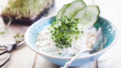 cottage cheese in a blue bowl with cucumbers