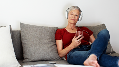 woman listening to music and drinking wine