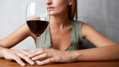 mature white woman with a wine glass in front of her