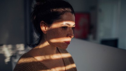 woman with her face in shadow
