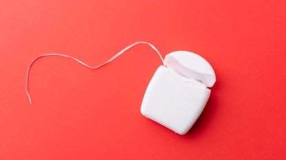 dental floss on red background