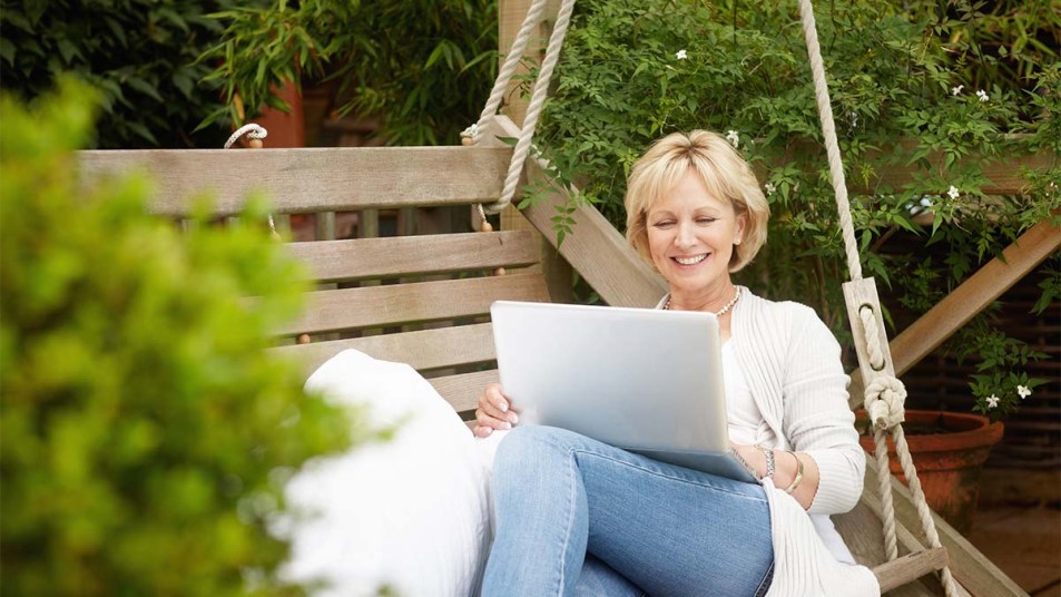 Woman reading her laptop outside