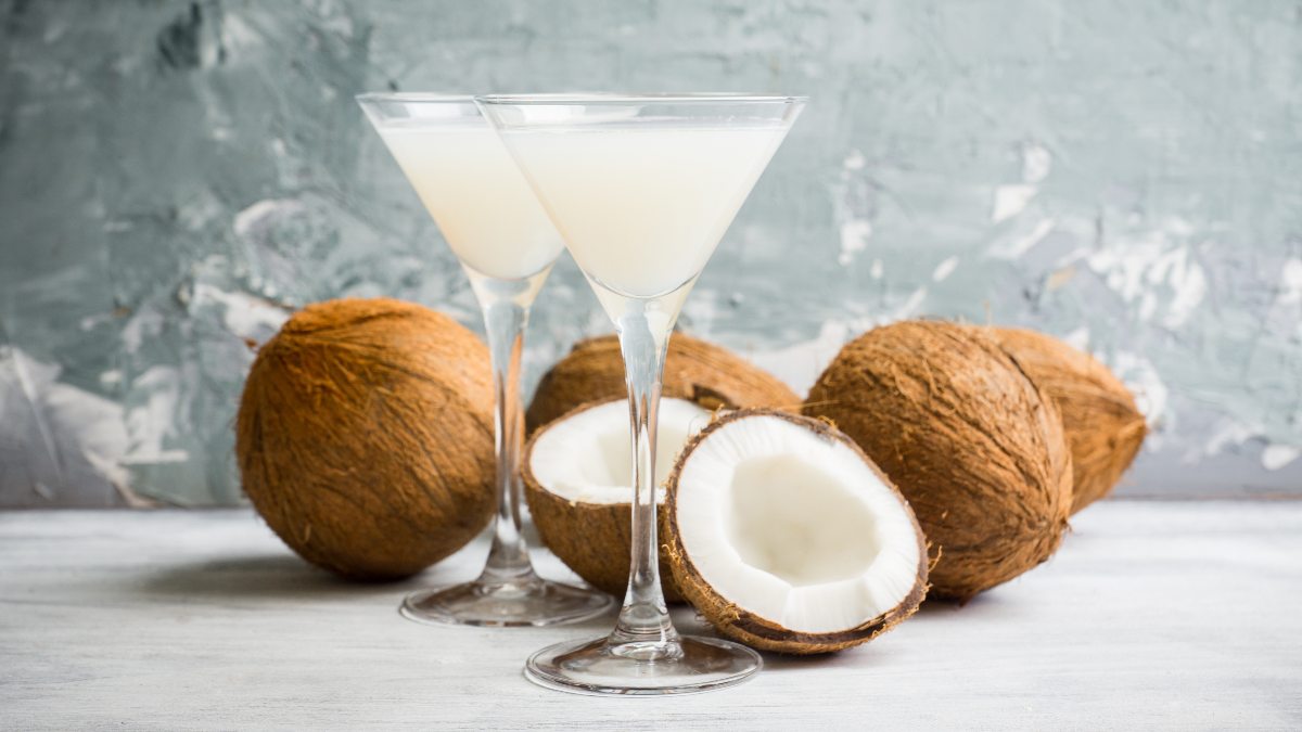 coconut martini with coconuts in background