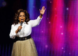 oprah winfrey waving on stage