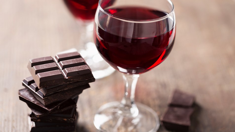 Red wine in a glass and chocolate bars beside it