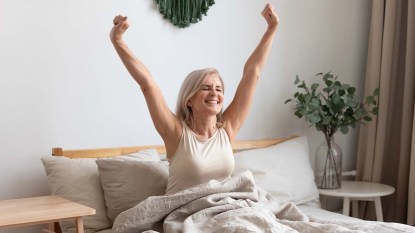 Woman-waking-up-refreshed-and-recharged-after-a-good-nights-sleep