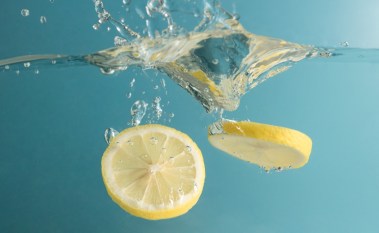 Lemon slices falling into water with a splash