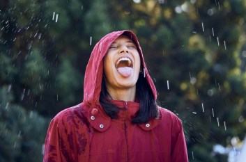 Woman outside in the rain with her tongue sticking out
