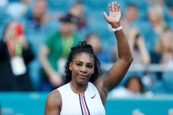 Serena Williams waves to crowd after winning tennis match