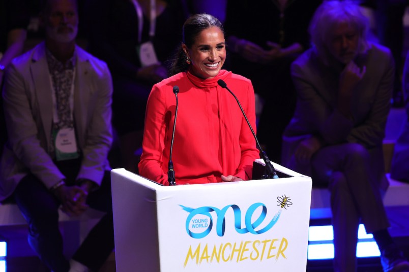 Meghan Markle stands at podium at One Young World event in Manchester