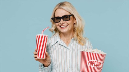 Happy-woman-wearing-3D-glasses-watch-movie-film-hold-bucket-of-popcorn-and-cup-of-soda